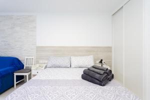 a bedroom with a large bed and a blue couch at Listen THE STARS 505 - Los cristianos in Los Cristianos +29 photos