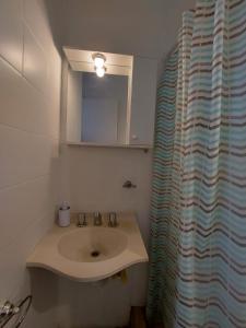 a bathroom with a sink and a shower curtain at Quinta Park in Mendoza +25 photos