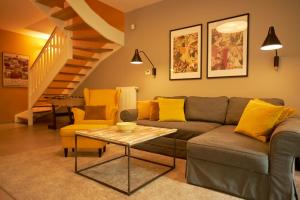 a living room with a couch and a table at SeaYou Yellow House in Rogowo