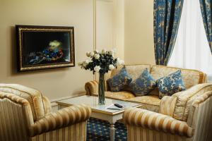 a living room with a couch and a table at Hotel Volgograd in Volgograd