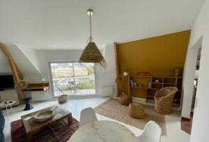 a living room with a large window and a table at Superbe appartement 4 personnes Le Pouliguen avec vue magnifique sur le port et la mer in Le Pouliguen +6 photos
