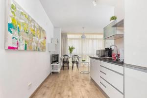 a kitchen with a counter and chairs in a room at Apartamento Soho Malaga in Málaga