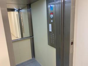 a elevator in a building with a window and a mirror at Air-conditioned, 2 room apartment with terrace in Bratislava