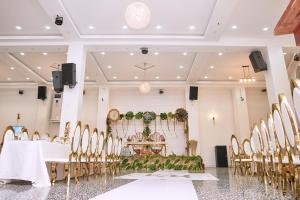 a conference room with a table and chairs at Convivium Home Hotel in Douala