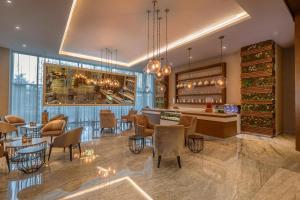 a restaurant with a bar and tables and chairs at Moon Palace The Grand Cancun All Inclusive in Cancún