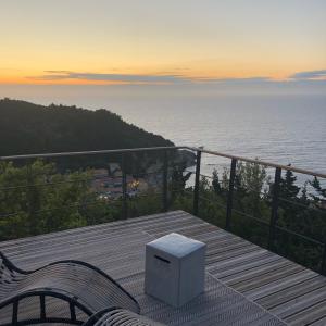 a bench on a deck with a view of the ocean at Myrto Homes Lefkada Agios Nikitas Greece in Agios Nikitas