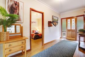 a room with a mirror and a dresser and a bedroom at Farm Stay & Iconic Water Views - 32 Zachary Drive in Mallacoota