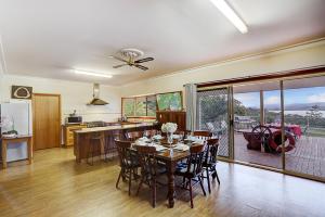 a kitchen and dining room with a table and chairs at Farm Stay & Iconic Water Views - 32 Zachary Drive in Mallacoota