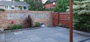 a backyard with a brick fence and a patio at 2 Bed semi-detached house in Poole