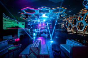 a room with a bar with blue and purple lights at Moon Palace Cancun - All Inclusive in Cancún +98 photos