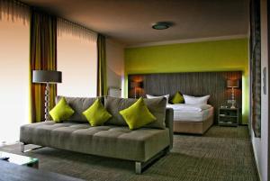 ヴァルドルフにあるHotel Ambiente Walldorfのソファとベッド付きのホテルルーム