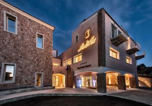 a building with a sign on the side of it at Your lovely and elegant home with garden sea view in La Maddalena