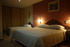 Rúm í herbergi á Hotel Castilla