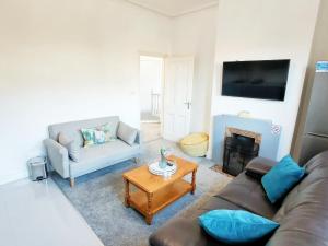 a living room with a couch and a table at C-New Flat,4 Adults,20 mins to Beach,Netflix,Wifi in Bournemouth