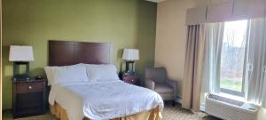 A bed or beds in a room at Kittanning Plaza Hotel