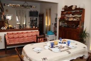 a dining room with a table with plates on it at B&B Porta del Mare in Genoa