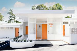 a white house with orange doors and plants at THE BERRY VIEW in Berry