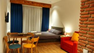 a bedroom with a bed and a table and chairs at Victoria's Panoramic View, ALPIC in Gudauri +69 photos