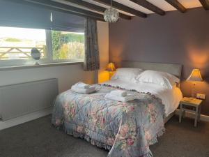 a bedroom with a bed with towels on it at Mill House in Whitby