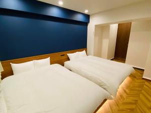 Ένα ή περισσότερα κρεβάτια σε δωμάτιο στο TABISAI HOTEL Suite 博多