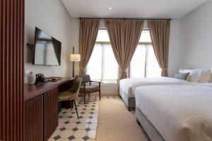 Postel nebo postele na pokoji v ubytování La Chronique Hotel