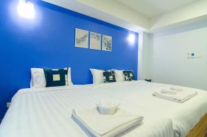 Postel nebo postele na pokoji v ubytování Bleu Marine Sattahip Hotel