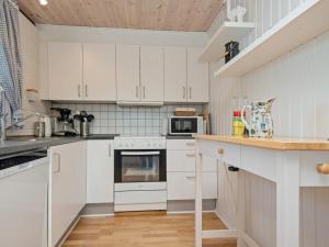 a kitchen with white cabinets and a counter top at 6 person holiday home in Skjern in Skjern
