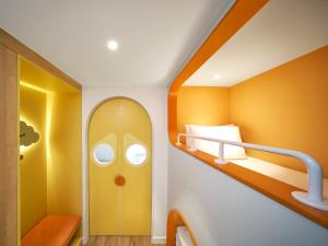 a small room with a bunk bed and a hallway at Holiday Inn Resort Ho Tram Beach by IHG in Ho Tram