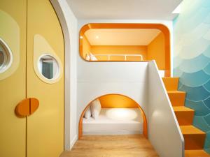 a childrens room with a bunk bed and a staircase at Holiday Inn Resort Ho Tram Beach by IHG in Ho Tram