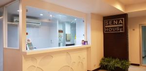 a sena house store with a sign on the window at Sena House Lamlukka Klong2 in Pathum Thani
