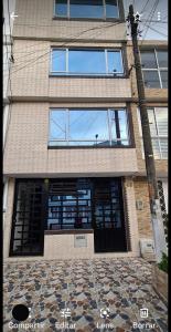 a tall building with a large door with windows at Apartamento Ynj#2 in Bogotá