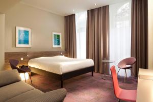 Postel nebo postele na pokoji v ubytování Hôtel Gutenberg
