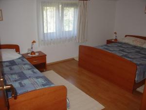 Postel nebo postele na pokoji v ubytování Apartments Mirjana