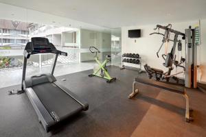 a gym with two treadmills and two exercise bikes at Episode Kuta Bali in Kuta
