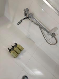 艾尔Ayr Traveller's Motel的白色瓷砖地板上的淋浴头