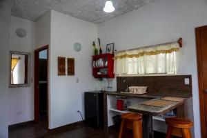 une cuisine avec un comptoir, une table et des tabourets dans l'établissement Darwin's temple, à San Cristóbal