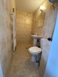 a bathroom with a toilet and a sink at TOP SKY VIEW - Studio Panorama in Veliko Tŭrnovo
