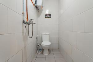 a bathroom with a toilet and a shower at RedDoorz near Riau Junction Mall 2 in Bandung