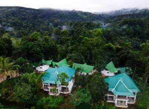 an aerial view of a house with green roofs at Misty Lake Resorts Munnar By Sylora Hotels in Munnar