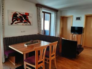 a living room with a table and a couch at Bauernhof Burglehen in Wagrain