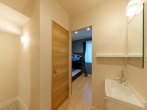 a bathroom with a sink and a door to a bedroom at YADOYA Ueno-Rikyu in Tokyo +24 photos