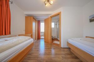 Posteľ alebo postele v izbe v ubytovaní Appartementhaus Chalet Alpina