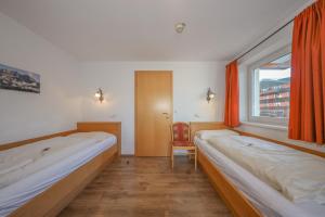 Posteľ alebo postele v izbe v ubytovaní Appartementhaus Chalet Alpina