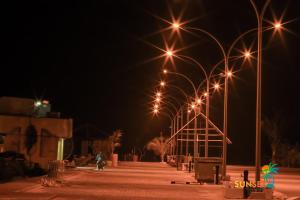 a row of lights on a street at night at Sunset Beach View in Dhangethi