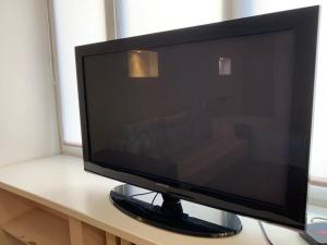 a flat screen television sitting on a desk at Мельникайте 96 ЦЕНТР Источники in Tyumen