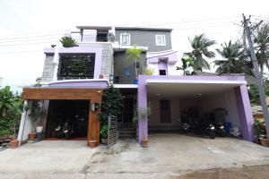 a large house with purple paint on it at The Ideal Nest Kumbakonam in Kumbakonam