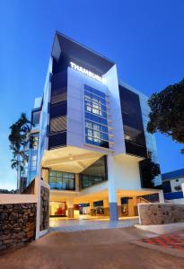 a large white building with a lot of windows at Hotel Thamburu International in Trivandrum