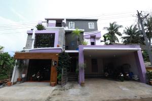 a house with a garage in front of it at The Ideal Nest Kumbakonam in Kumbakonam