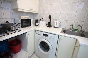 a kitchen with a washing machine and a sink at Ariadne 1, Sea Side Boutique Apartment in Limassol
