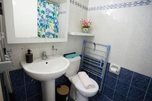 a small bathroom with a sink and a toilet at Ariadne 1, Sea Side Boutique Apartment in Limassol +28 photos